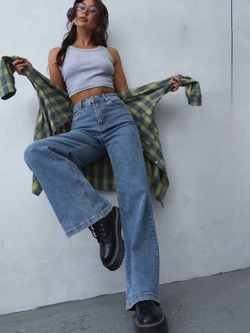 Women's light blue loose high-rise stretchable jeans with acid wash detailing.