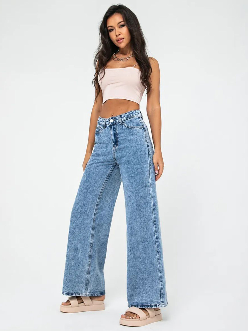 Women’s light blue wide leg high-rise stretchable jeans with low distress and heavy fade detailing.