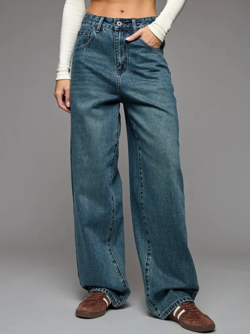 Women's green flared high-rise stretchable jeans with low distress and heavy fade detailing.