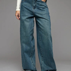 Women's green flared high-rise stretchable jeans with low distress and heavy fade detailing.