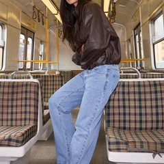 Women's light blue high-rise loose wide leg stretchable jeans.