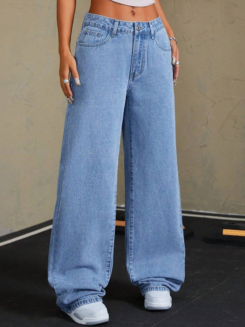 Women's blue mid-rise stretchable wide leg jeans with slash knee detailing.