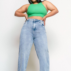 Women's light blue loose wide leg high-rise jeans with highly distressed detailing and heavy fade.