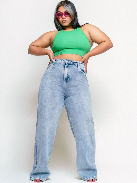 Women's light blue loose wide leg high-rise jeans with highly distressed detailing and heavy fade.