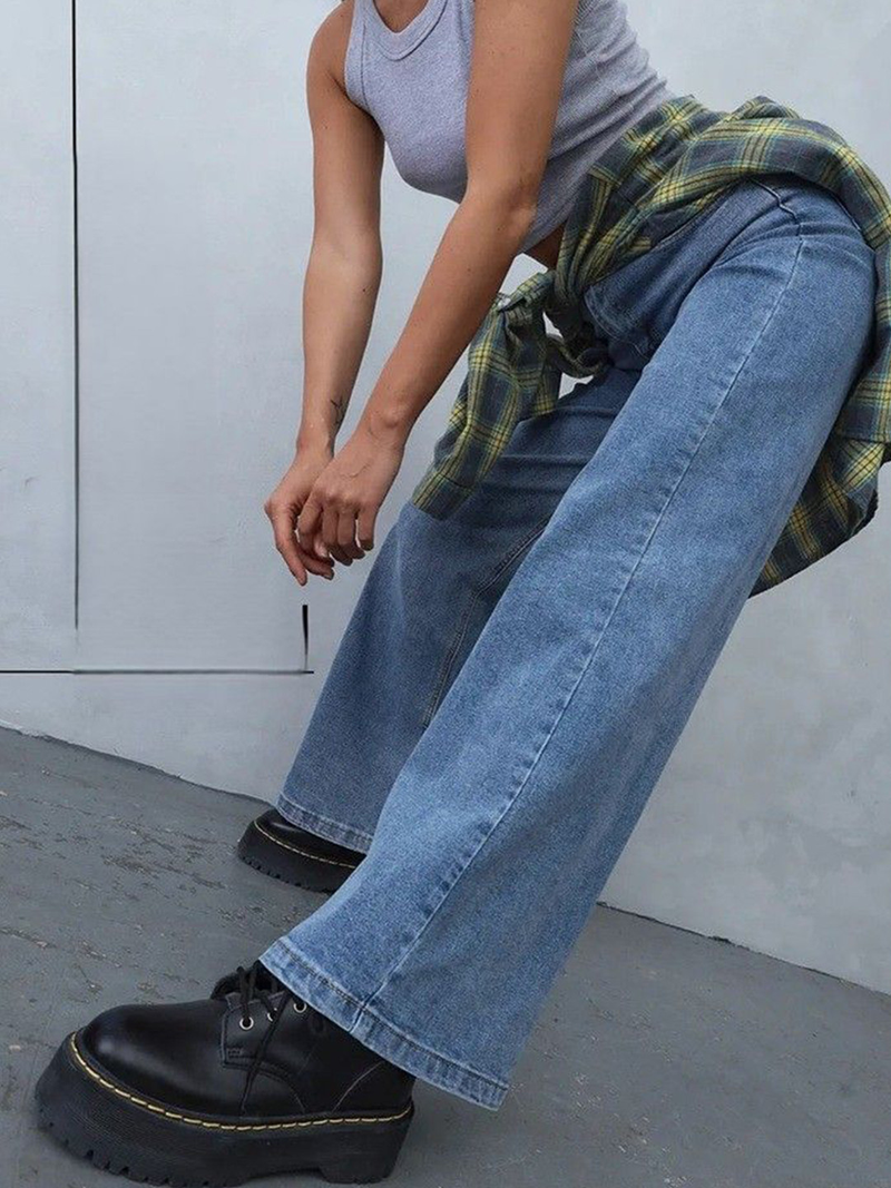 Women's light blue loose high-rise stretchable jeans with acid wash detailing.
