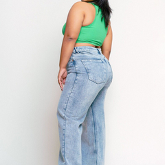 Women's light blue loose wide leg high-rise jeans with highly distressed detailing and heavy fade.