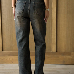 Women's brown high-rise straight fit stretchable jeans with heavy fade detailing.