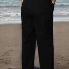 Women's black relaxed fit high-rise stretchable jeans with mildly distressed detailing.