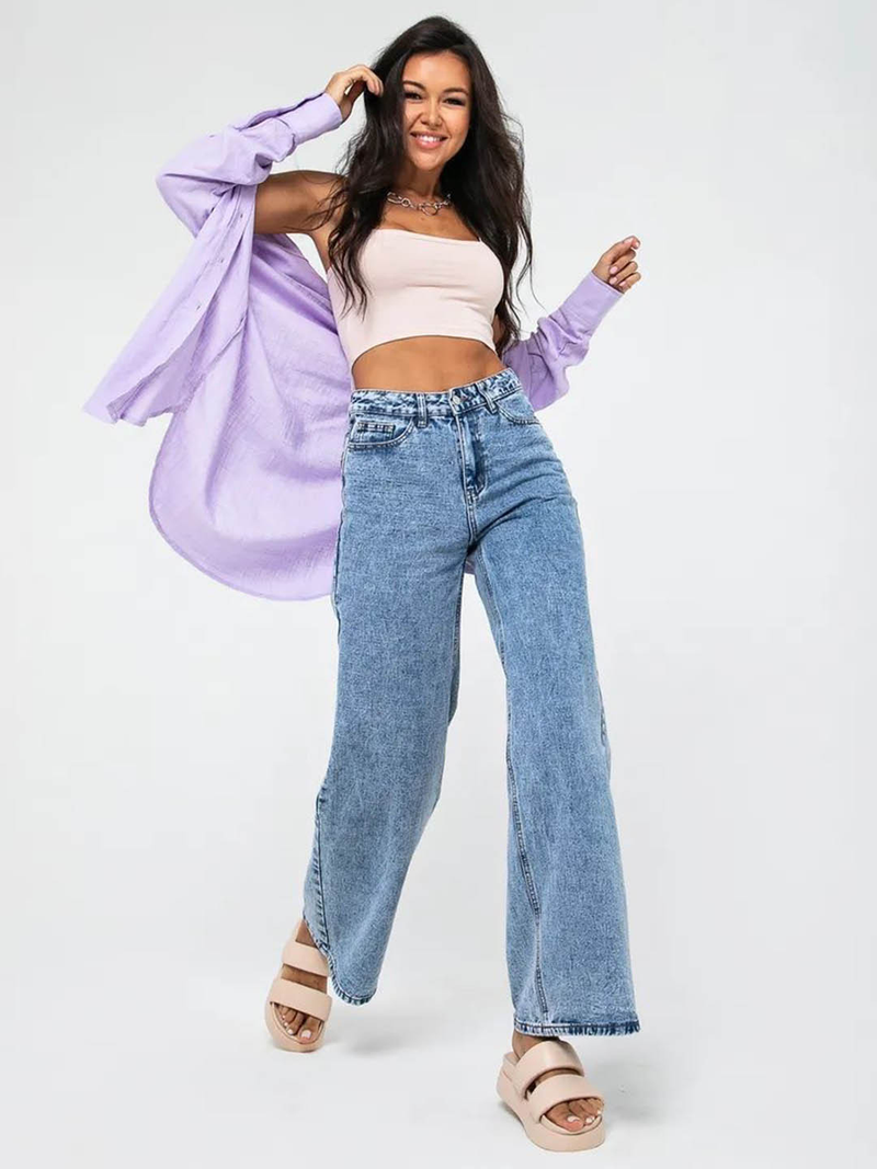 Women’s light blue wide leg high-rise stretchable jeans with low distress and heavy fade detailing.