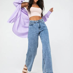 Women’s light blue wide leg high-rise stretchable jeans with low distress and heavy fade detailing.