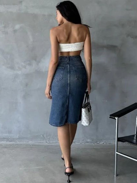 Women’s blue denim midi skirt with high-rise fit and back pocket design, styled with a white strapless top.