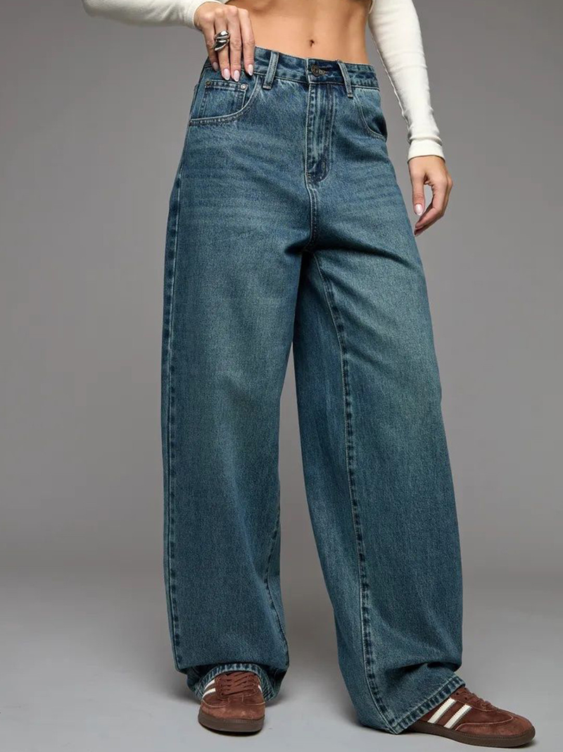 Women's green flared high-rise stretchable jeans with low distress and heavy fade detailing.