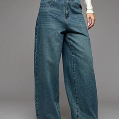 Women's green flared high-rise stretchable jeans with low distress and heavy fade detailing.