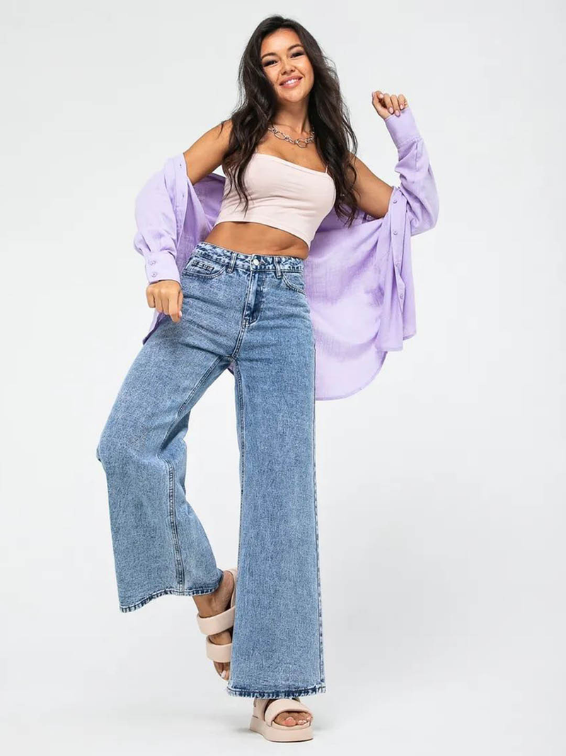 Women’s light blue wide leg high-rise stretchable jeans with low distress and heavy fade detailing.