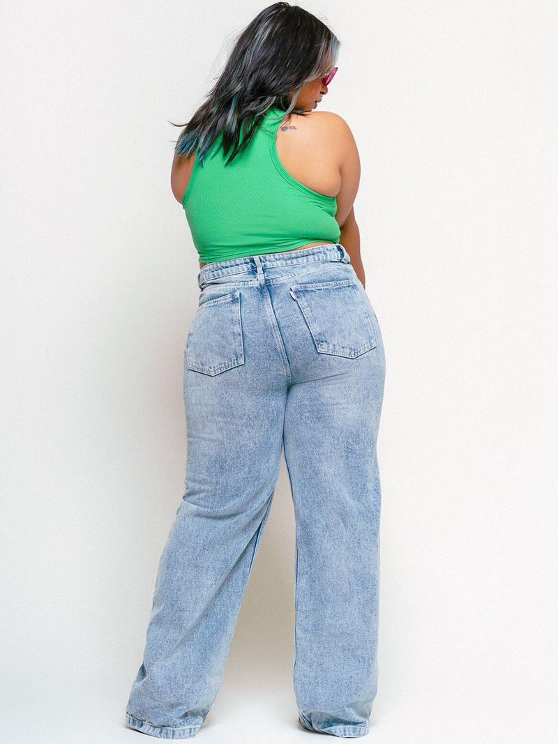 Women's light blue loose wide leg high-rise jeans with highly distressed detailing and heavy fade.