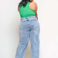 Women's light blue loose wide leg high-rise jeans with highly distressed detailing and heavy fade.