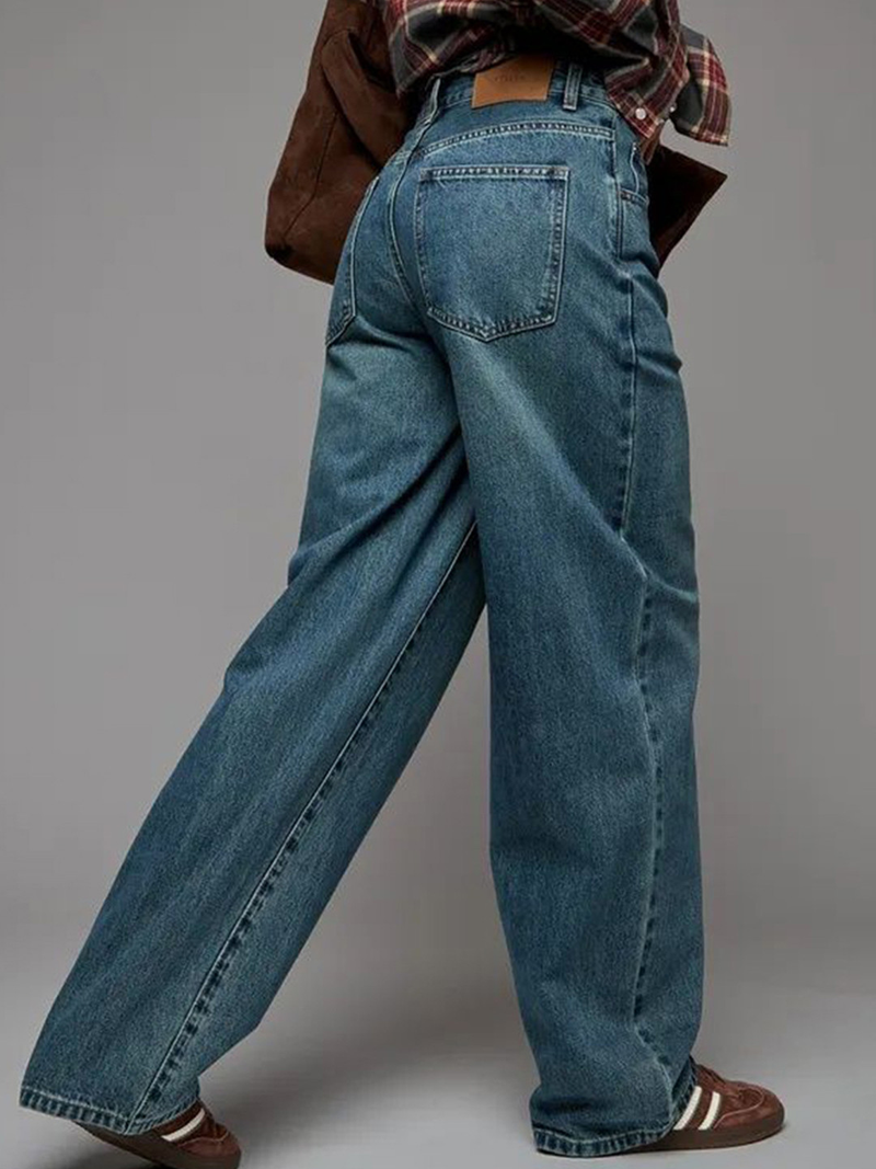 Women's green flared high-rise stretchable jeans with low distress and heavy fade detailing.