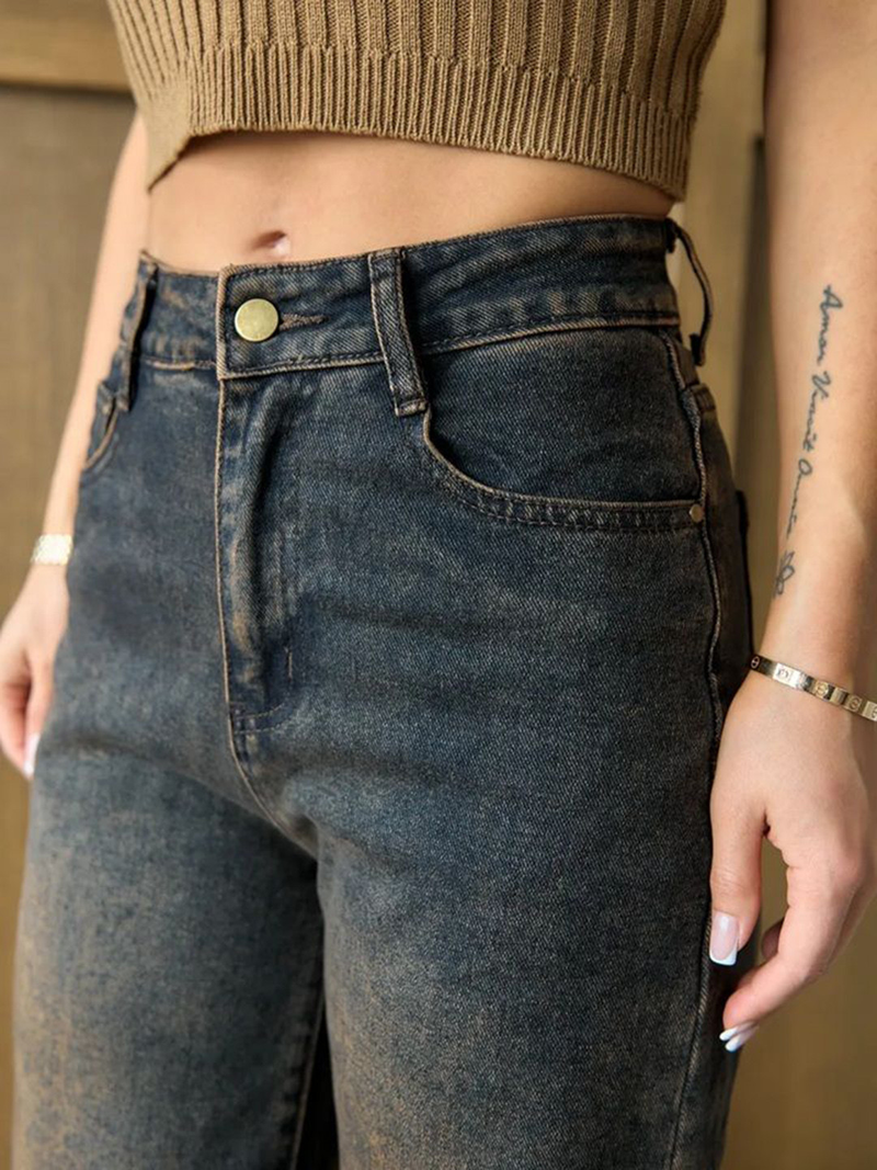 Women's brown high-rise straight fit stretchable jeans with heavy fade detailing.