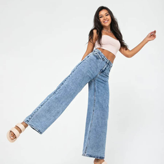 Women’s light blue wide leg high-rise stretchable jeans with low distress and heavy fade detailing.