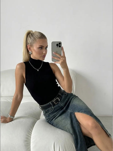 Women’s blue denim midi skirt with high-rise fit and back pocket design, styled with a white strapless top.