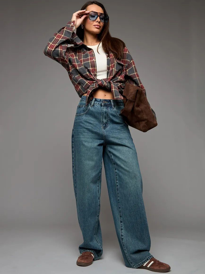 Women's green flared high-rise stretchable jeans with low distress and heavy fade detailing.