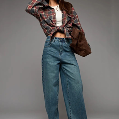 Women's green flared high-rise stretchable jeans with low distress and heavy fade detailing.