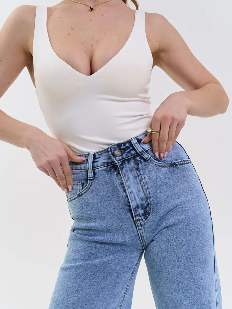 Women's light blue wide leg high-rise stretchable jeans with light fade and pleated detailing.