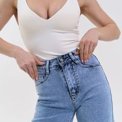 Women's light blue wide leg high-rise stretchable jeans with light fade and pleated detailing.