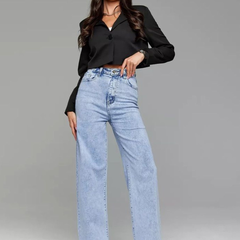 Women's light blue wide leg high-rise stretchable jeans with light fade detailing.