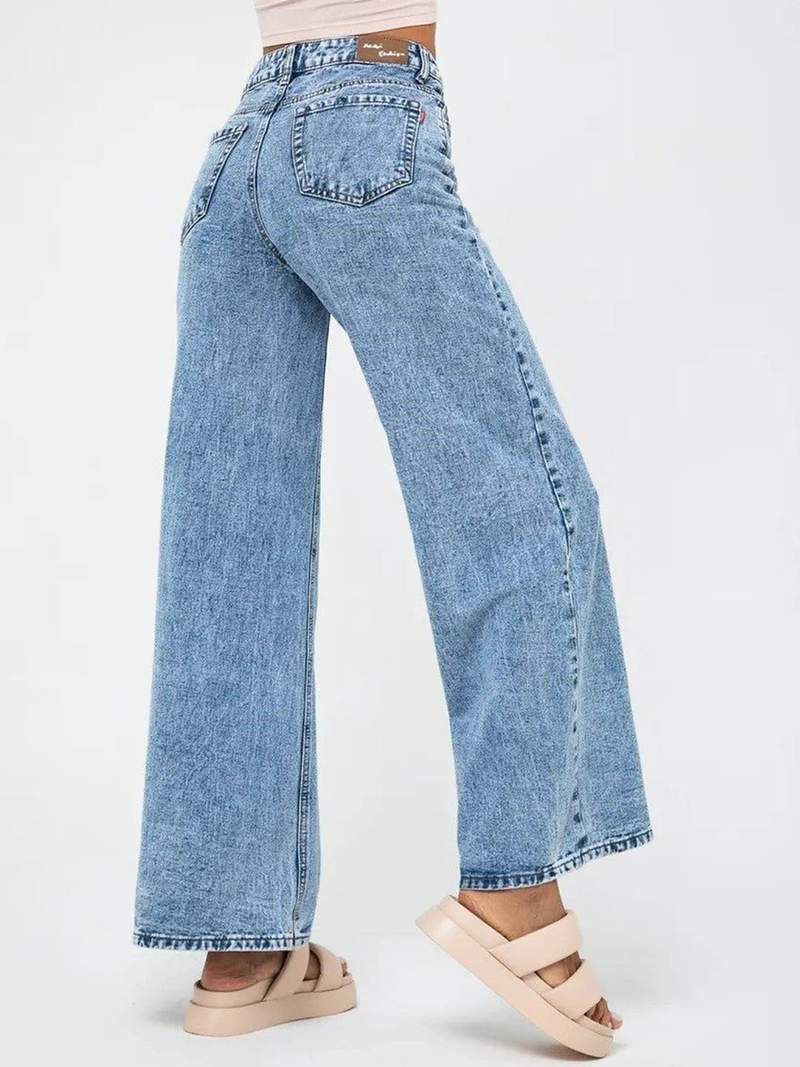 Women’s light blue wide leg high-rise stretchable jeans with low distress and heavy fade detailing.