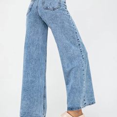 Women’s light blue wide leg high-rise stretchable jeans with low distress and heavy fade detailing.