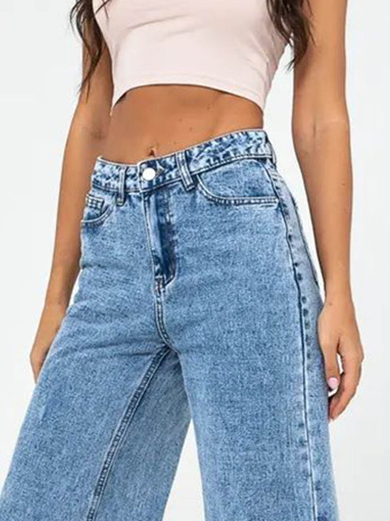 Women’s light blue wide leg high-rise stretchable jeans with low distress and heavy fade detailing.