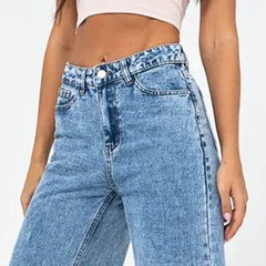 Women’s light blue wide leg high-rise stretchable jeans with low distress and heavy fade detailing.